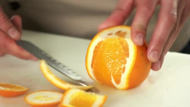 Hands with knife peeling fruit. — Stock Video
