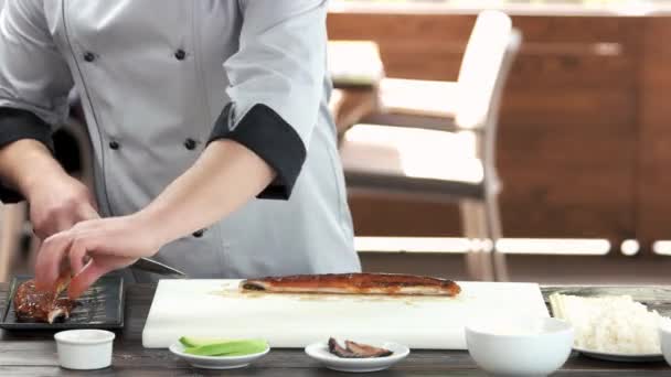 Chef-kok snijden gerookte paling. — Stockvideo