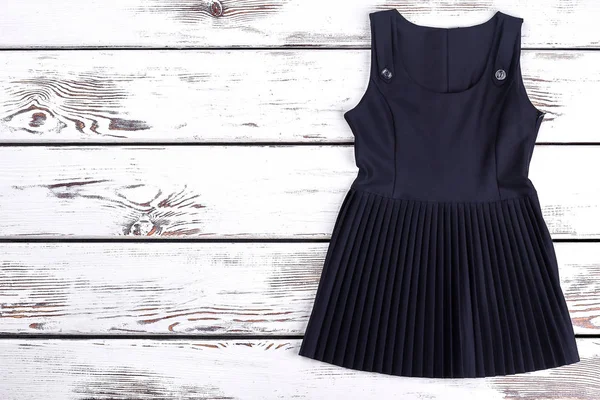 Black pleated classic dress for schoolgirl. — Stock Photo, Image