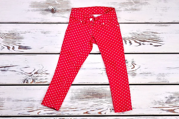 Beautiful red jeans for school child. — Stock Photo, Image