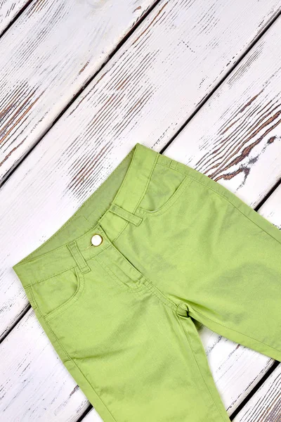 Kids green trousers, top view.