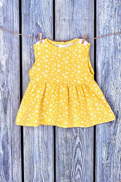 Baby-girl casual dress on clothesline.