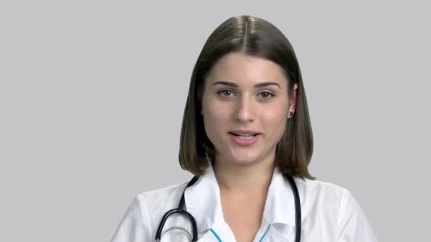 Smiling beautiful doctor talking to the camera. — Stock Video