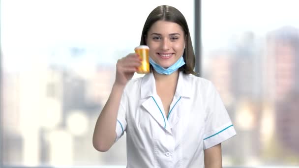 Happy female doctor holding pills. — Stock Video