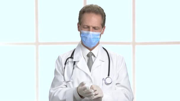 Serious strong middle aged doctor in bright hospital room. — Stock Video