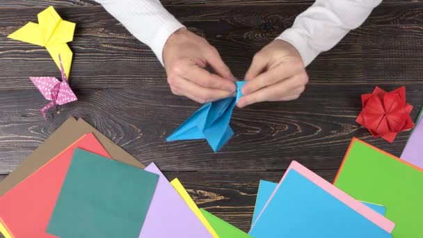 Mann macht Origami-Kran, Ansicht von oben. — Stockvideo
