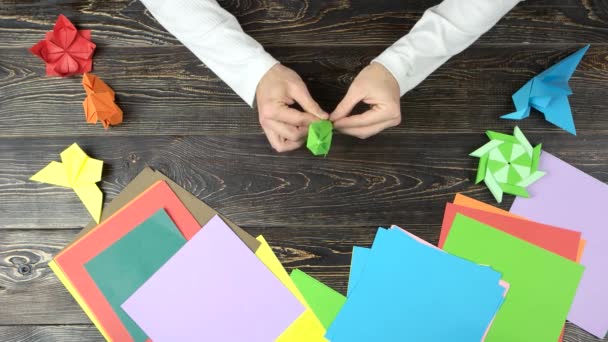 Male hands making origami boat. — Stock Video