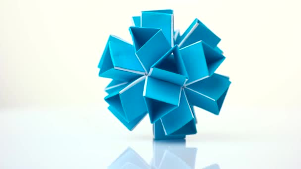 Blue kusudama figure on white background. — Stock Video