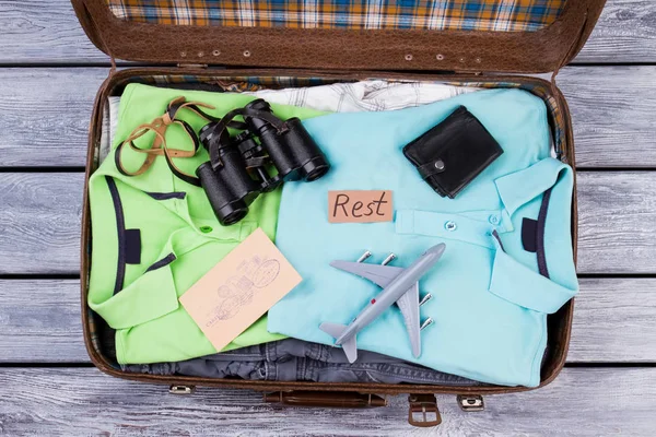 Travel accessories in opened suitcase.