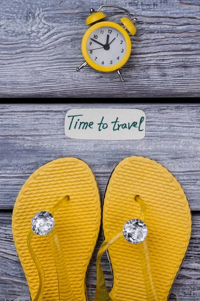 Yellow luxury footwear and alarm clock. — Stock Photo, Image