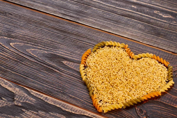 Valentines Day background with pasta in heart shape. — Stock Photo, Image