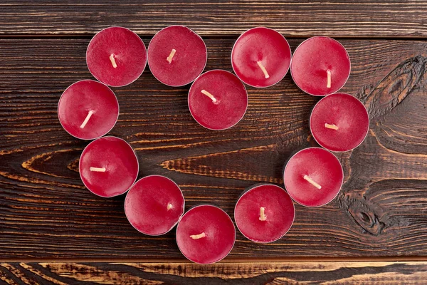Tea light candles forming shape of heart.