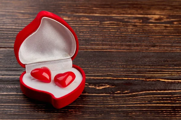 Red velvet box with heart shaped earrings.