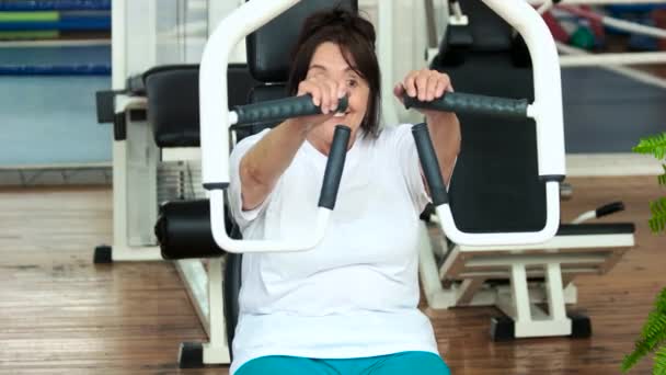 Mujer mayor haciendo ejercicio de peso de empuje de prensa . — Vídeos de Stock
