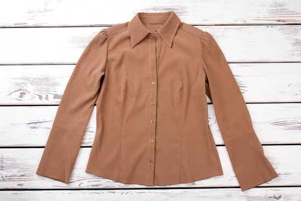 Female brown color formal shirt.