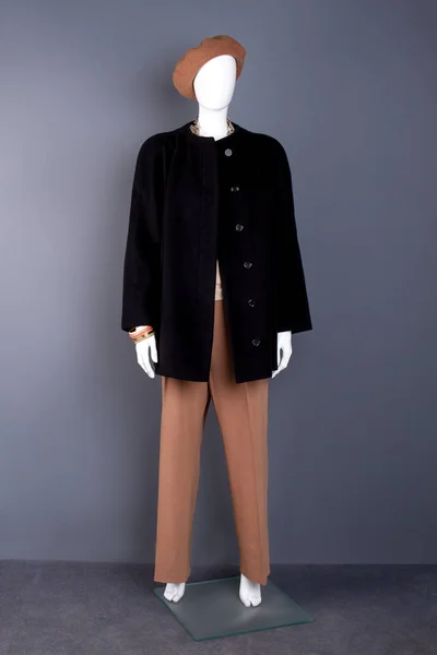 Full length female mannequin in modern apparel.