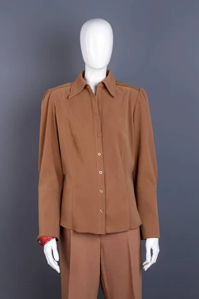 Mannequin in female brown shirt.