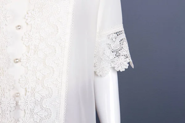 Close up female white lace blouse.
