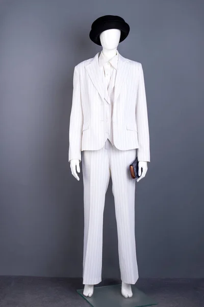 Mannequin in white suit and black hat.