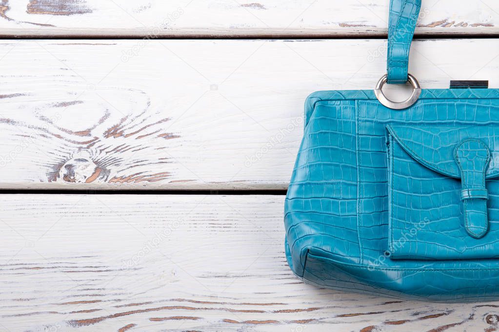 Female blue leather handbag, copy space.