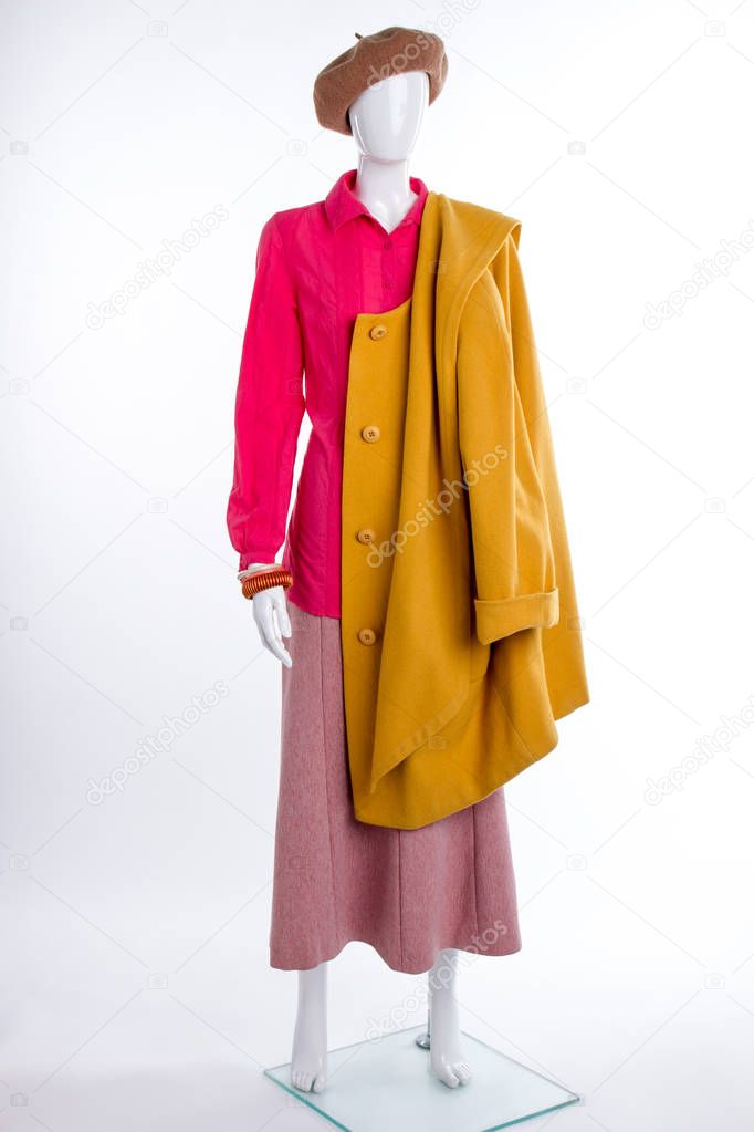 Female mannequin with yellow coat.