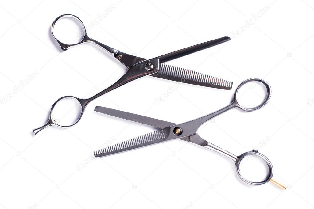 Hairdressing scissors on a white background.