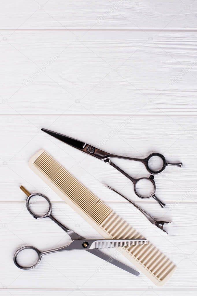 Hairdressing scissors and comb, top view.