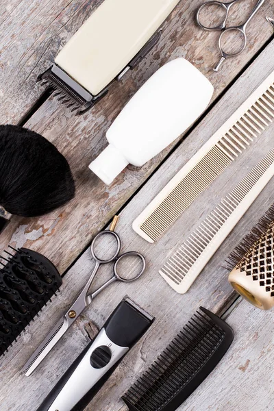 Hairdresser set for men on wooden background.