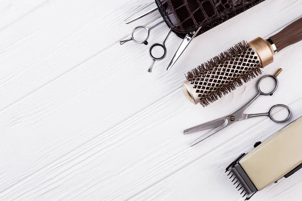 Hairdressing equipment on wooden background.