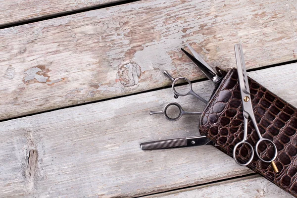 Professional hairdresser scissors on wooden background. Stock Photo by  ©Denisfilm 321452460