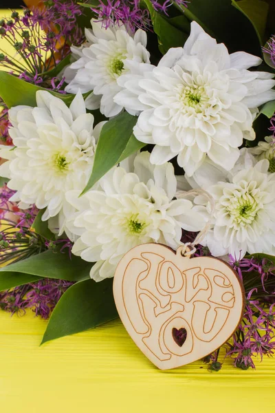 Flowers and wooden heart.