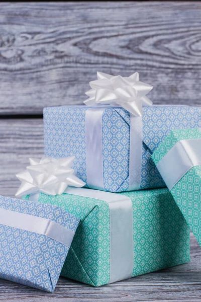 Pile of gift boxes on wooden background.