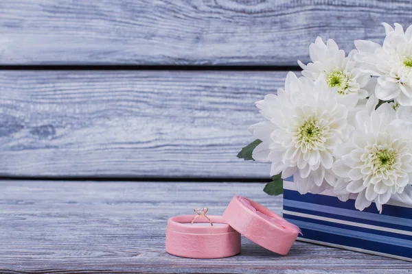 Flowers and box with diamond ring.