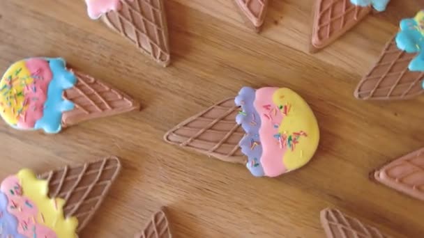 Cookies with colorful icing on wooden background. — Stock Video