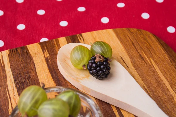 Rustic wooden spoon with and berries. — Stock Photo, Image