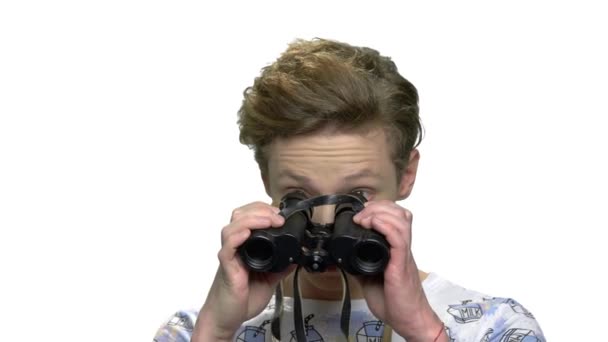 Curious teen boy looking through binoculars. — Stock Video