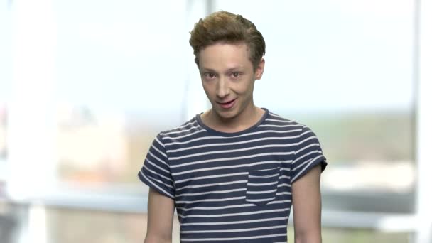 Portrait of funny teenage boy in striped t-shirt. — Stock Video