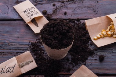 Round fibr pot and different grain seeds.