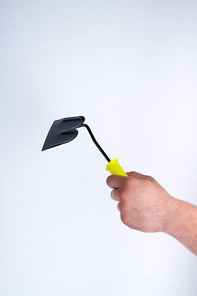 Mans holding one-handed steel hoe tool. — Stockfoto