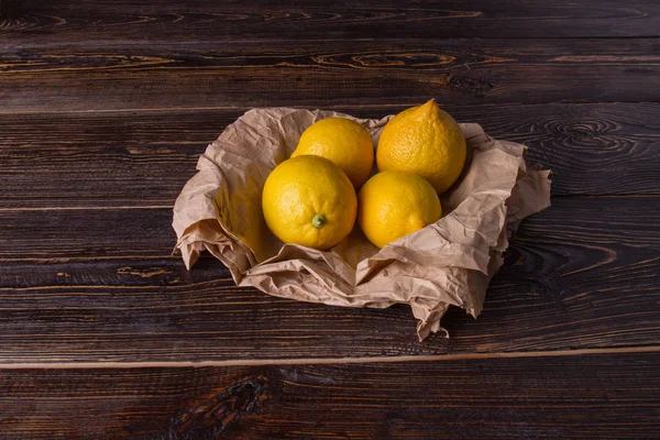 Cuatro limones frescos sobre mesa de madera . — Foto de Stock