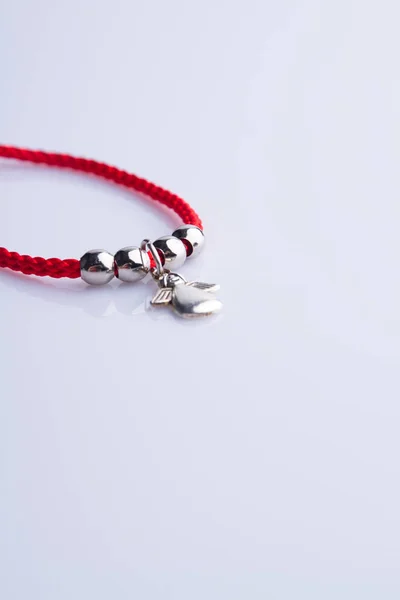 Red necklace with silver angel and round beads. — Stock Photo, Image