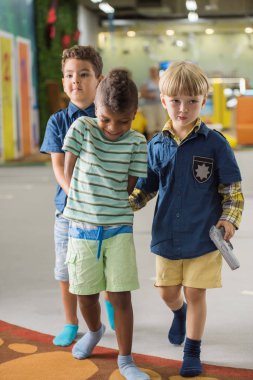 Two little policemen and thief in playroom.