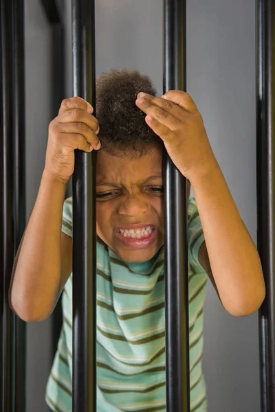 Kid prisoner try to escape from jail. — Stock Photo, Image