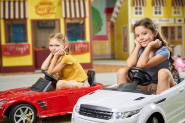 Cute kids looking at camera at game center.