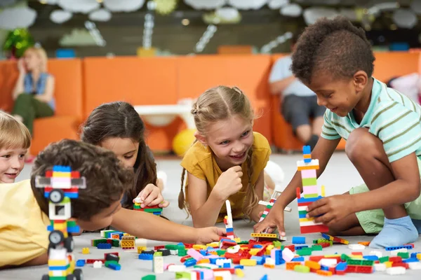 Group of funny kids playing with block toys indoor. — Stock Photo, Image