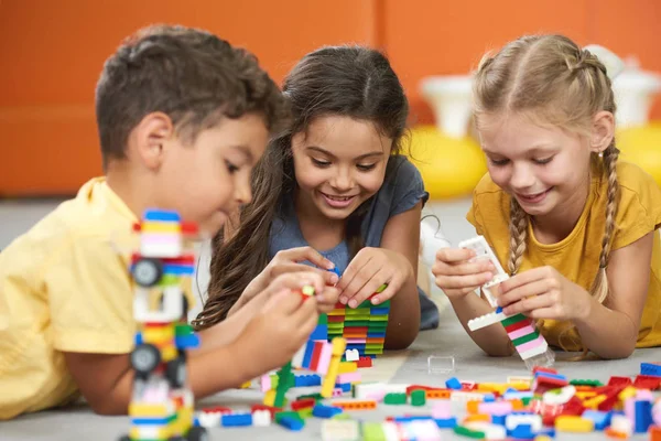 Happy kids playing with constructor at kindergarten. — Stock Photo, Image
