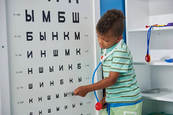 Médecin enfant vérifiant la vue des patients dans la salle d'ophtalmologie . — Photo