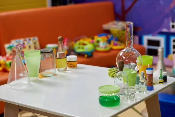 Laboratory glassware on table in playroom. — Stock Photo, Image