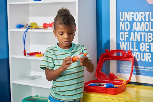 Cute boy doctor playing in medical office. — Stock Photo, Image