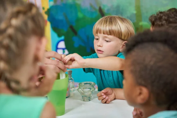 Happy little boy having fun with his friends at playroom. — Stock Photo, Image